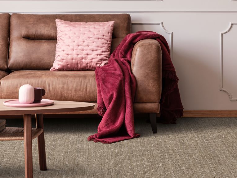 textured brown carpets in a modern living room with pink accents